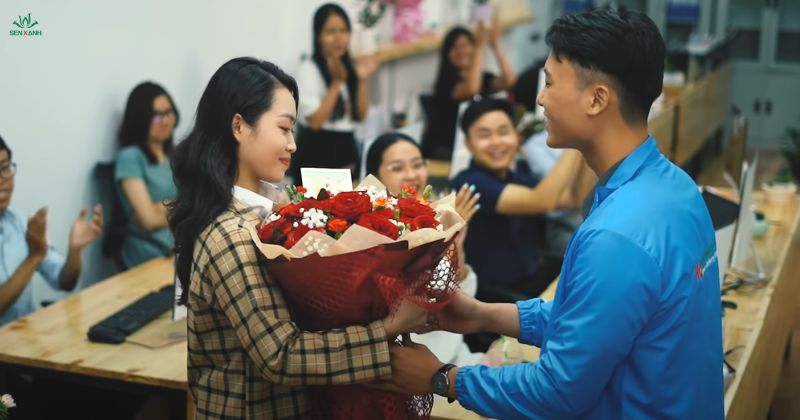 Nhân viên nam tặng hoa cho phái đẹp